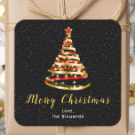 Red and Gold Ribbon Tree Merry Christmas Square Sticker<br><div class="desc">This elegant and chic holiday sticker can be personalized with your family name. The design features a red and gold ribbon Christmas tree with a star topper. The text combines handwritten script and modern sans serif fonts for a classy and sophisticated look. The falling snow, snowflakes and sparkles give a...</div>