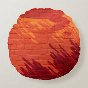 Red and orange painted brick wall round pillow
