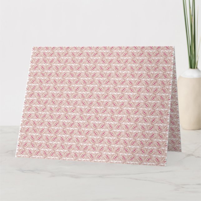 Red and pink textiles laid over a patterned rug wi card (Front)