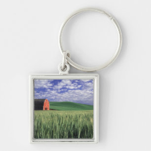 Red barn in wheat & barley field in Whitman Keychain