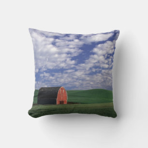 Red barn in wheat & barley field in Whitman Throw Pillow