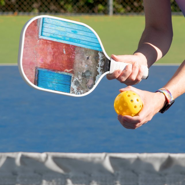 Red, blue and grey wall, door and window pickleball paddle (Insitu)