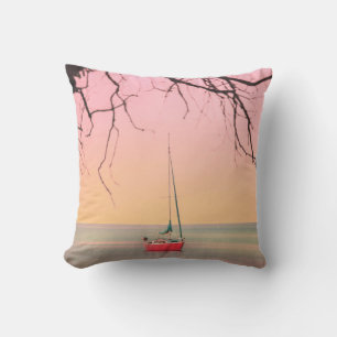 RED BOAT ON BEACH DURING SUNSET THROW PILLOW