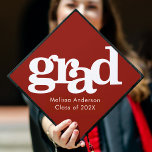 Red bold simple modern graphic typography name graduation cap topper<br><div class="desc">Your favourite grad will stand out and make a statement when they wear this graduation cap topper! Let them celebrate their milestone with this stunning, simple, modern, custom graduation keepsake. Bold, graphic, white typography overlays a brick red background. Personalize with your grad’s name and class year. Matching announcements, address labels,...</div>