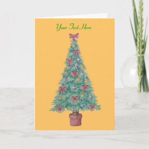 red bows and bells on decorated tree for christmas holiday card