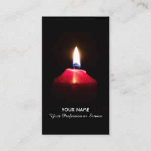 Red candle light illuminates the dark business card