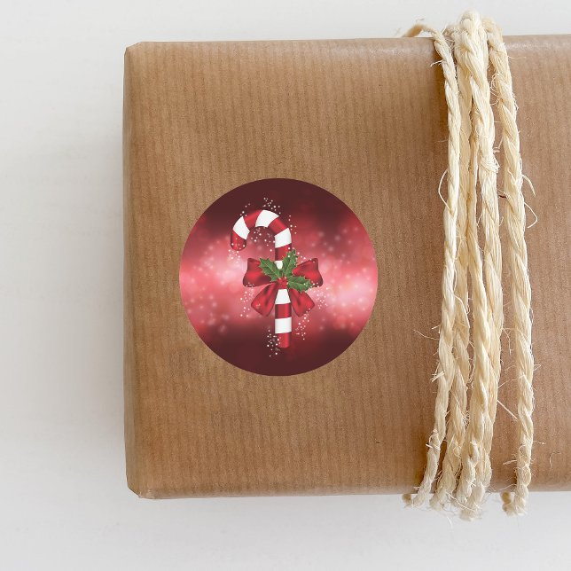 Red Candy Cane On A Red Bokeh Background Classic Round Sticker (Festive design for the Holiday season.)