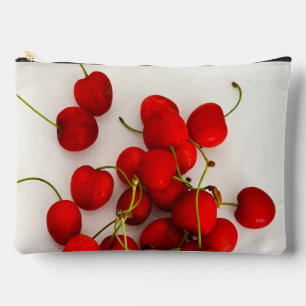 Red Cherries in Natural Light Lay on White Accessory Pouch