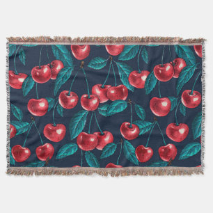 Red cherries on dark blue throw blanket