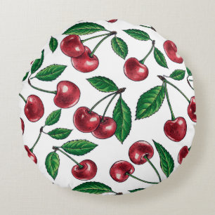 Red cherries on white round pillow