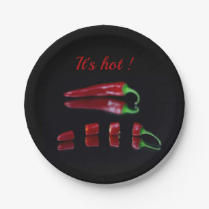 Red chili on black photo with text paper plate