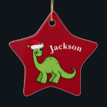 Red Christmas Kids Dinosaur Santa Star Custom Ceramic Ornament<br><div class="desc">Awesome green dinosaur smiling and looking very cute in a holiday red Santa hat. I like prehistoric Christmas animals and presents that kids will love. Customize this gift with the recipient's name to make it even more personalized.</div>