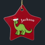 Red Christmas Kids Dinosaur Santa Star Custom Ceramic Ornament<br><div class="desc">Awesome green dinosaur smiling and looking very cute in a holiday red Santa hat. I like prehistoric Christmas animals and presents that kids will love. Customize this gift with the recipient's name to make it even more personalized.</div>