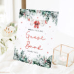 Red Christmas Santa Baby Shower Guest Book Sign<br><div class="desc">The Red Santa Gender Neutral Santa Baby Clothes Christmas Baby Shower Guest Book Sign adds a delightful, festive touch to your holiday-themed baby shower. With delicate snowflakes, eucalyptus greenery, and adorable Santa-inspired baby clothes, this sign warmly invites guests to leave their heartfelt messages and signatures in the guest book. It’s...</div>