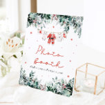 Red Christmas Santa Baby Shower Photo Booth Sign<br><div class="desc">The Red Santa Gender Neutral Santa Baby Clothes Christmas Baby Shower Photo Booth Sign adds a festive and fun touch to your holiday-themed baby shower! Featuring a bright red design with delicate snowflakes, eucalyptus greenery, and adorable Santa-inspired baby clothes, this sign warmly invites guests to snap memorable photos at the...</div>