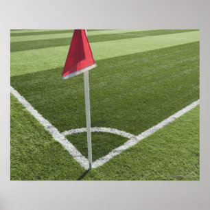 Red corner flag on soccer field poster