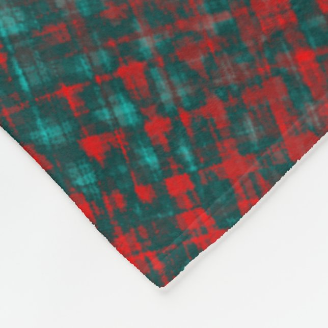 Red crisscrossing scratches over charred cyan      fleece blanket (Corner)