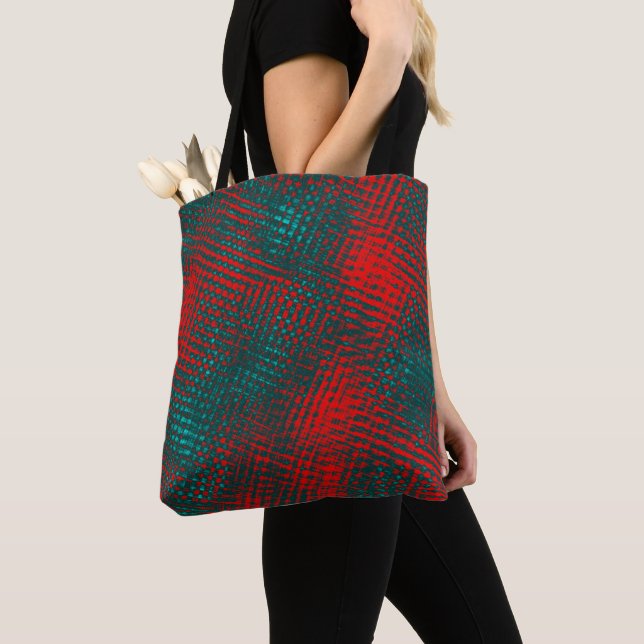 Red crisscrossing scratches over charred cyan      tote bag (Close Up)
