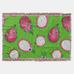 Red dragon fruit on green throw blanket