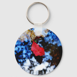 Red floating fall leaf with reflection of blue sky keychain