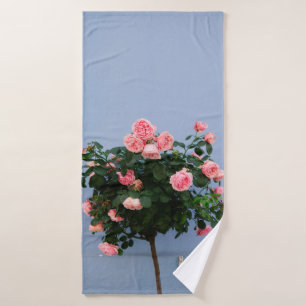 Red flowers with green leaves on blue wall bath towel