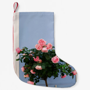 Red flowers with green leaves on blue wall small christmas stocking