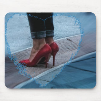 Red high heel shoes on a mousepad