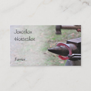Red hot horseshoe on an anvil business card