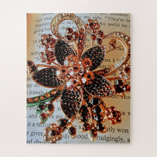 Red jewelled broach on print background jigsaw puzzle