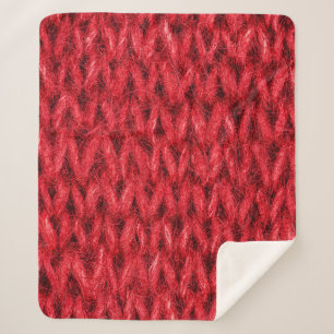 Red knitting wool texture background. sherpa blanket