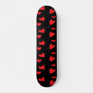 Red love hearts on black skateboard