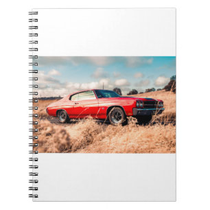 Red Muscle Car in grass. Notebook