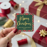 Red Plaid Gold Foil Script Merry Christmas Square Sticker<br><div class="desc">Red Plaid Gold Foil Script Merry Christmas Stickers featuring our modern typography of Merry Christmas in faux gold foil on a festive holiday background plaid of red, green, white, and stripes of more faux gold foil, set at a cozy angle. Designed by Cedar & String; please contact us at cedarandstring@gmail.com...</div>