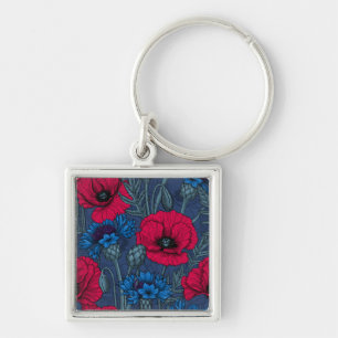 Red poppies and blue cornflowers on blue keychain