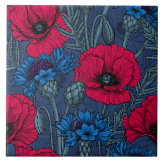 Red poppies and blue cornflowers on blue tile