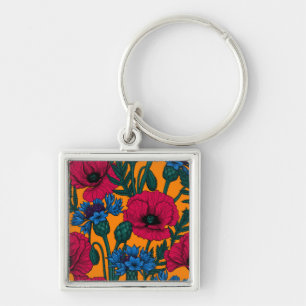 Red poppies and blue cornflowers on orange keychain