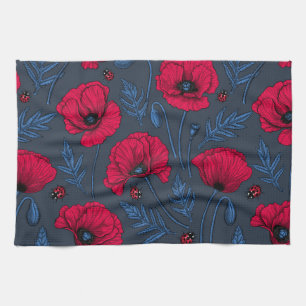 Red poppies and ladybugs on dark blue kitchen towel