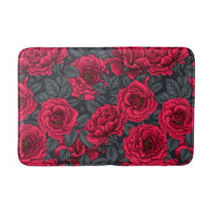 Red roses with grey leaves on black bath mat