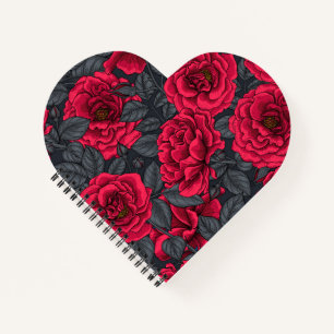Red roses with grey leaves on black notebook