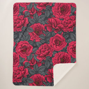 Red roses with grey leaves on black sherpa blanket