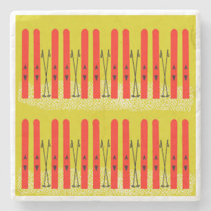 Red skis on yellow stone coaster