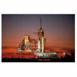 Red Sky for Space Shuttle Atlantis Launch Photo Sculpture Magnet<br><div class="desc">The crisp morning air was electric with anticipation as the first rays of dawn painted the sky a fiery red. The colossal white silhouette of the Space Shuttle Atlantis dominated the launchpad, dwarfed only by the immensity of the moment. A collective gasp rippled through the crowd as plumes of fire...</div>