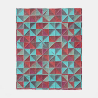 red, teal, purple, and gray quilt fleece blanket