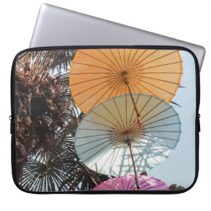Red umbrella on green tree laptop sleeve