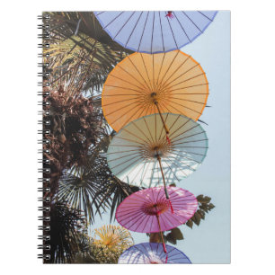 Red umbrella on green tree notebook