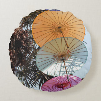 Red umbrella on green tree round pillow