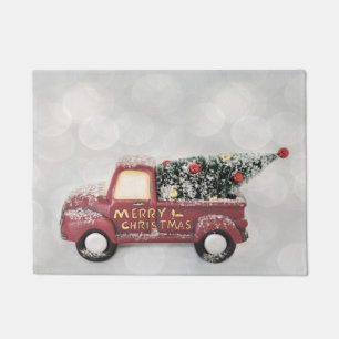red vintage truck on a grey bokeh background doormat