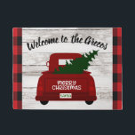 Red Vintage Truck with Christmas Tree Welcome Mat<br><div class="desc">Welcome your guests to your home this year with this festive personalized welcome mat featuring a vintage red pick up truck carrying a Christmas tree fresh from the farm. Easily personalize with your name or family name. Rustic wood, farmhouse style background and trendy red and black buffalo check. Part of...</div>