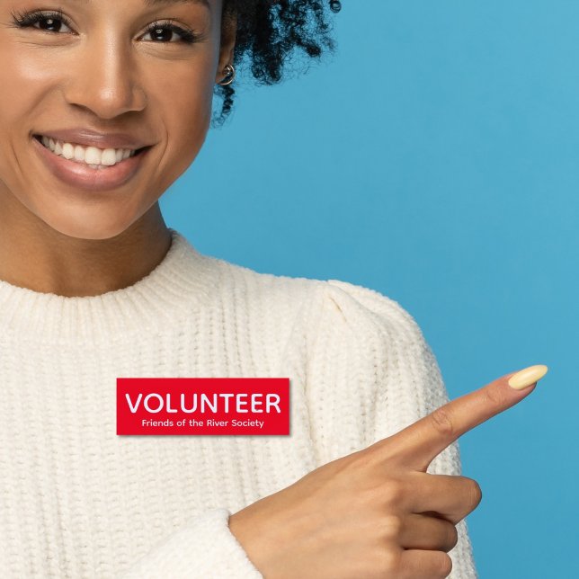 Red Volunteer Badge Name Tag (Woman in ivory sweater wearing this customizable volunteer name tag badge in red and white.)