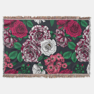 Red, white and bi-color roses with green leaves on throw blanket